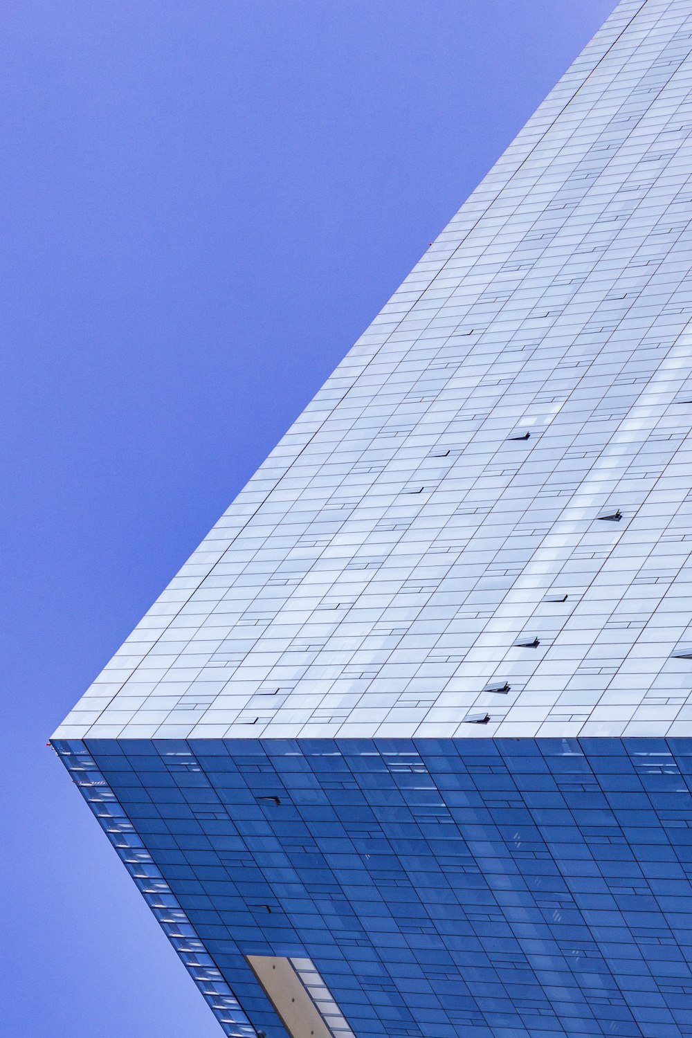 blue glass walled high-rise building