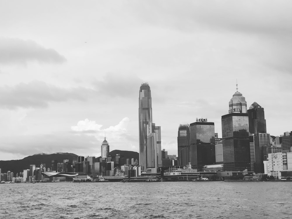grayscale photography of city with high-rise buildings viewing sea