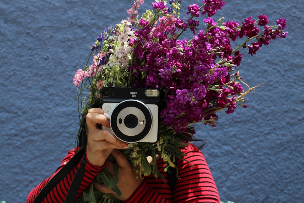 woman using black and grey camera