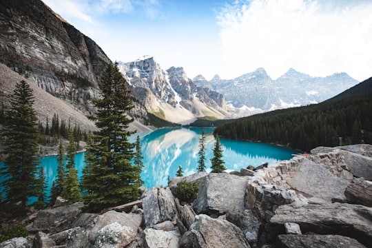 blue body of water near grey mountain during daytime in Moraine Lake Canada
