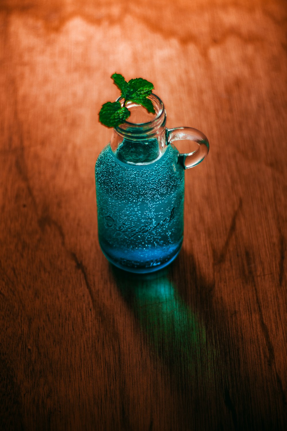 clear glass mug with blue liquid