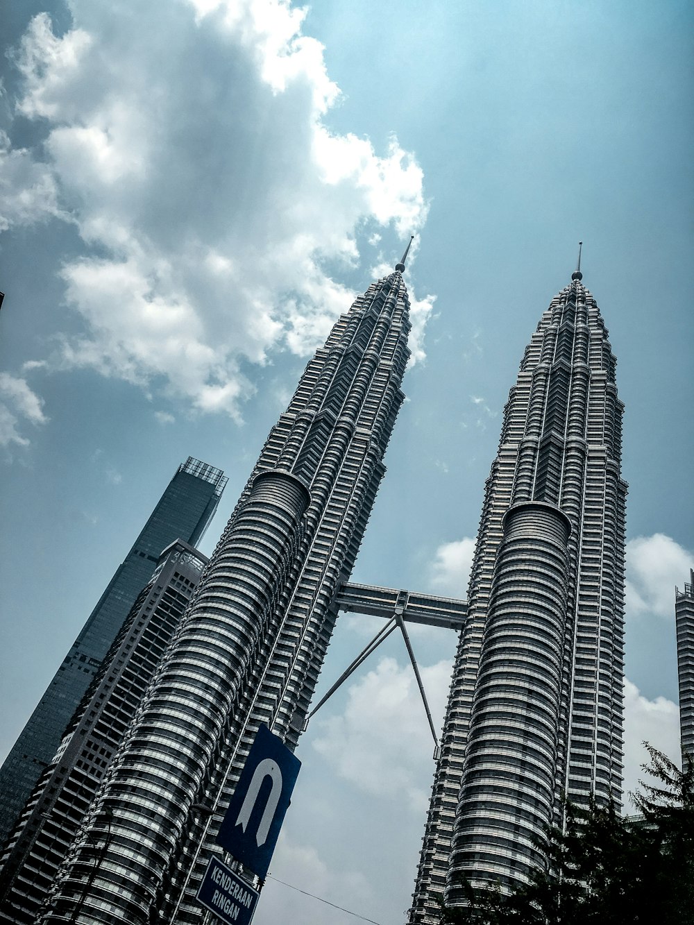 Petronas Tower under blue and white skies