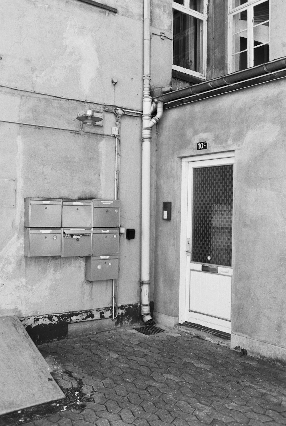 a black and white photo of a building with a door