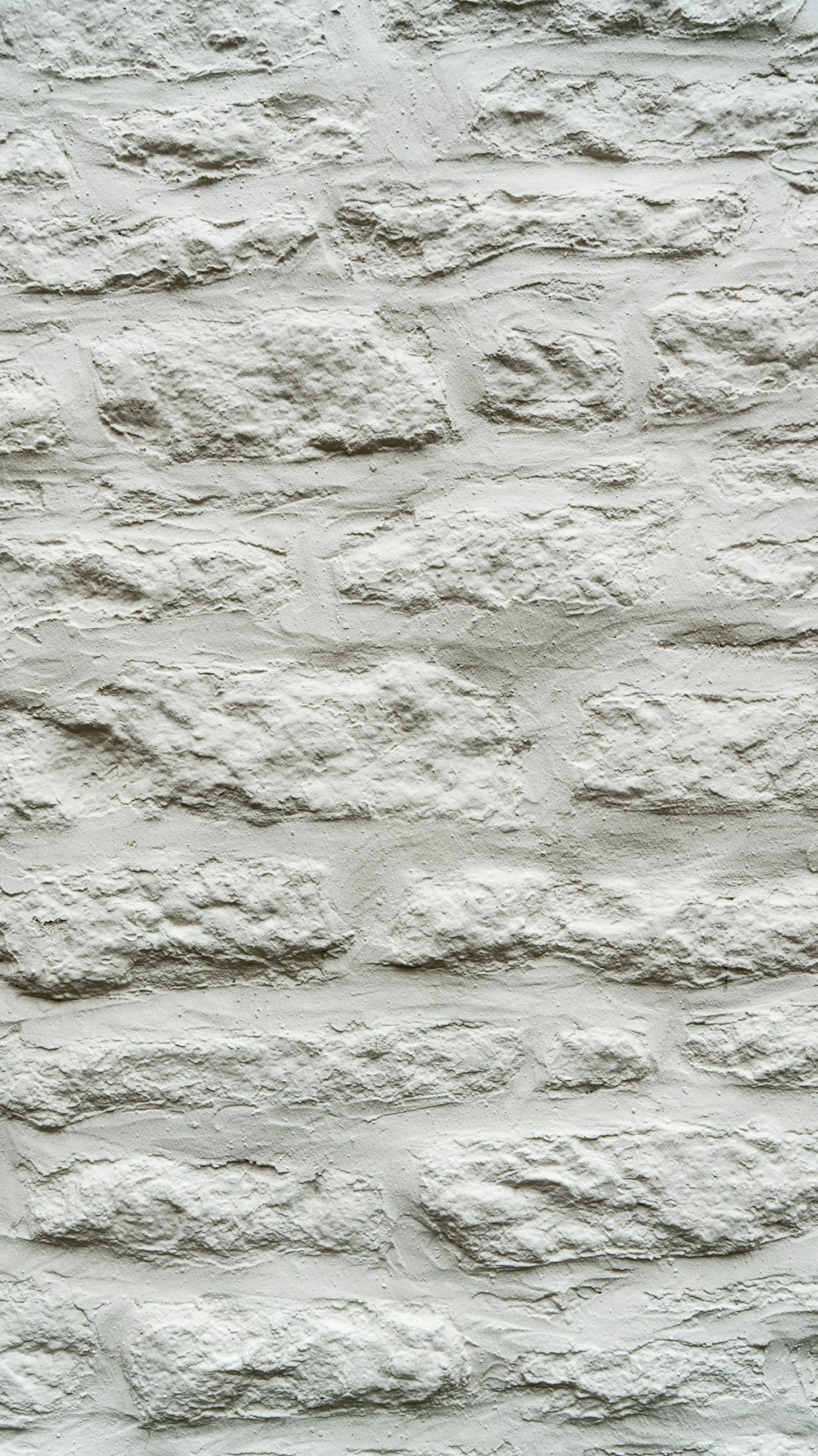 a white brick wall with a black and white clock