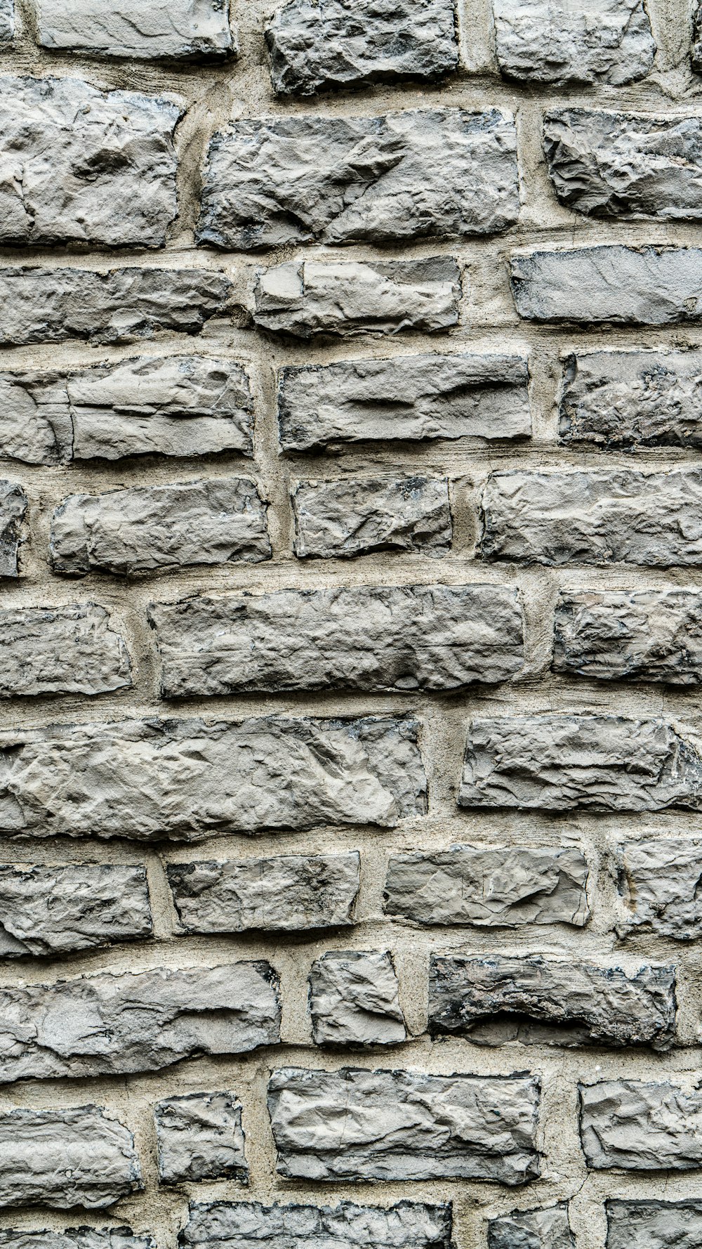 a close up of a brick wall made of stone