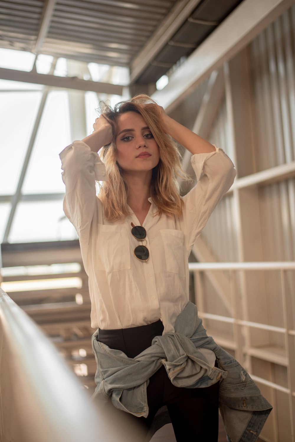 woman stands near white wall