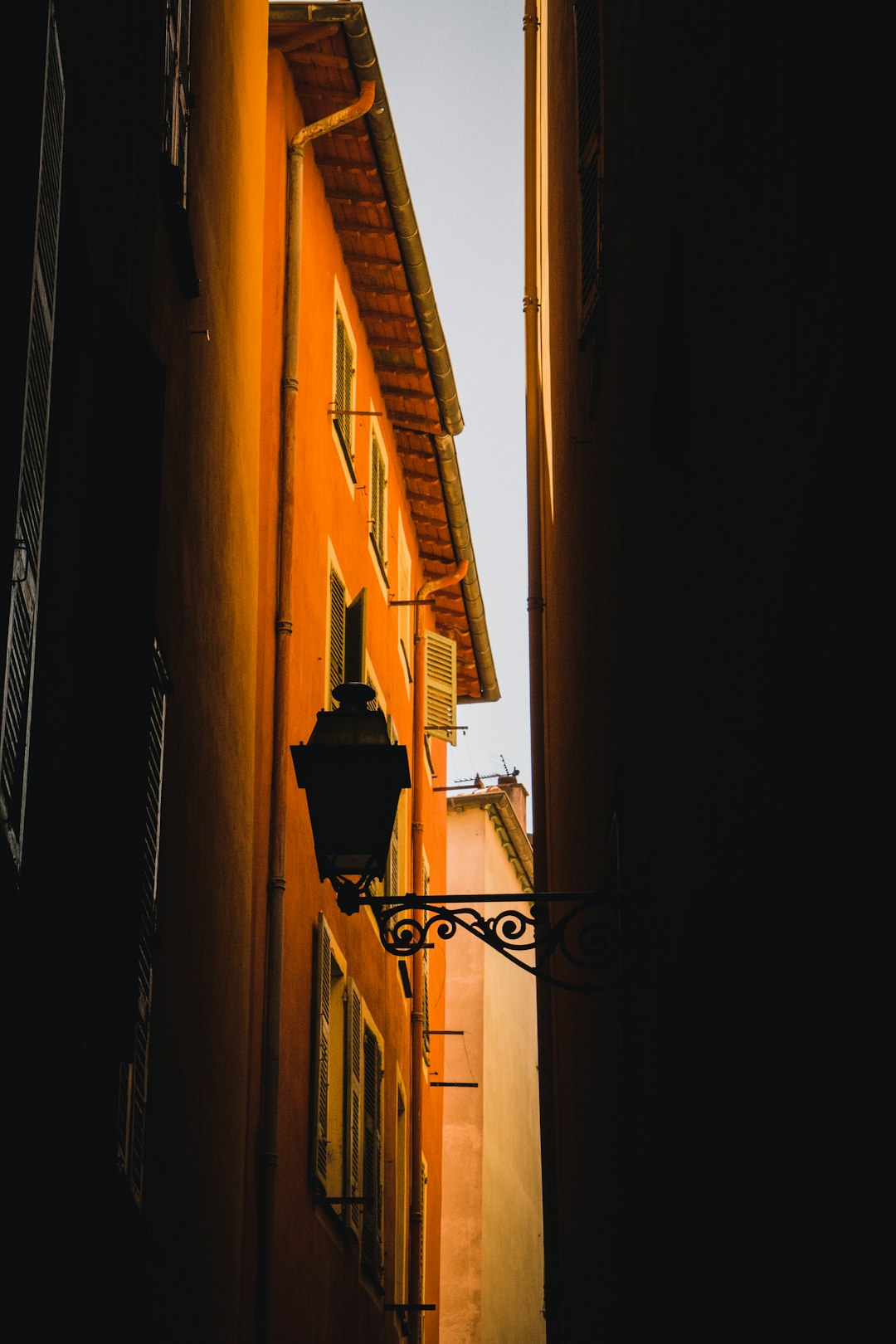 orange concrete building showing outdoor sconce