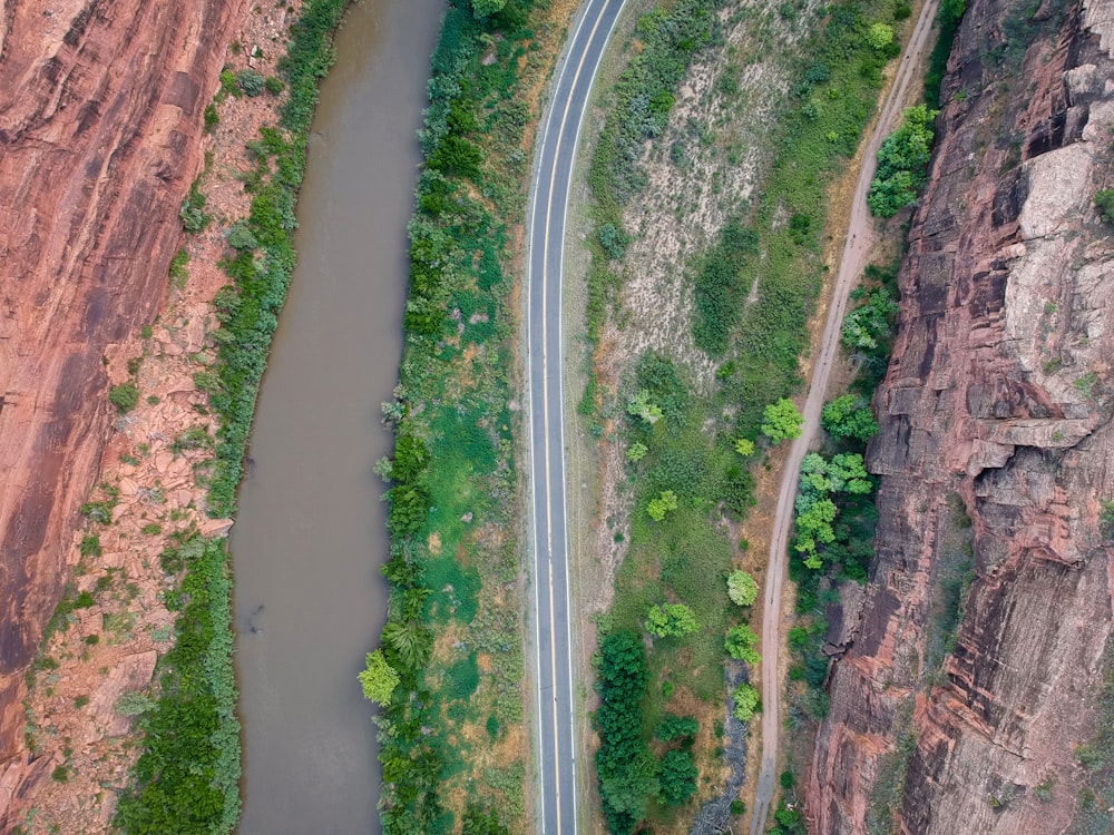 aerial photography of river beside road between mountains