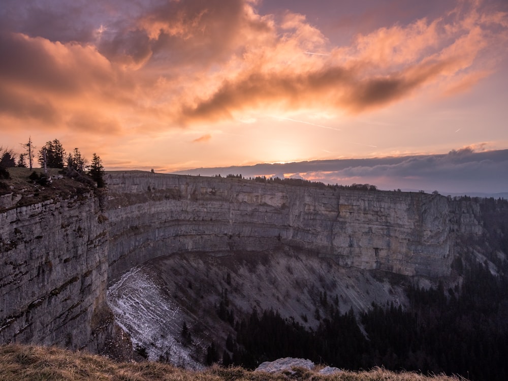 gray canyon under cloudy sky during golden hour