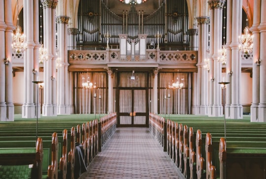 empty green wooden pew inside building in Iglesia Oscar Fredrik Sweden