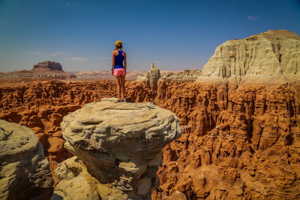 person standing on rock formation