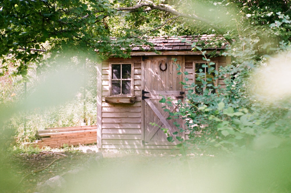 focus photography of brown wooden shed