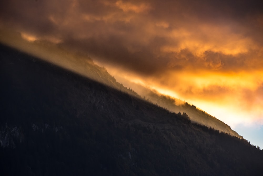 mountains under orange clouds