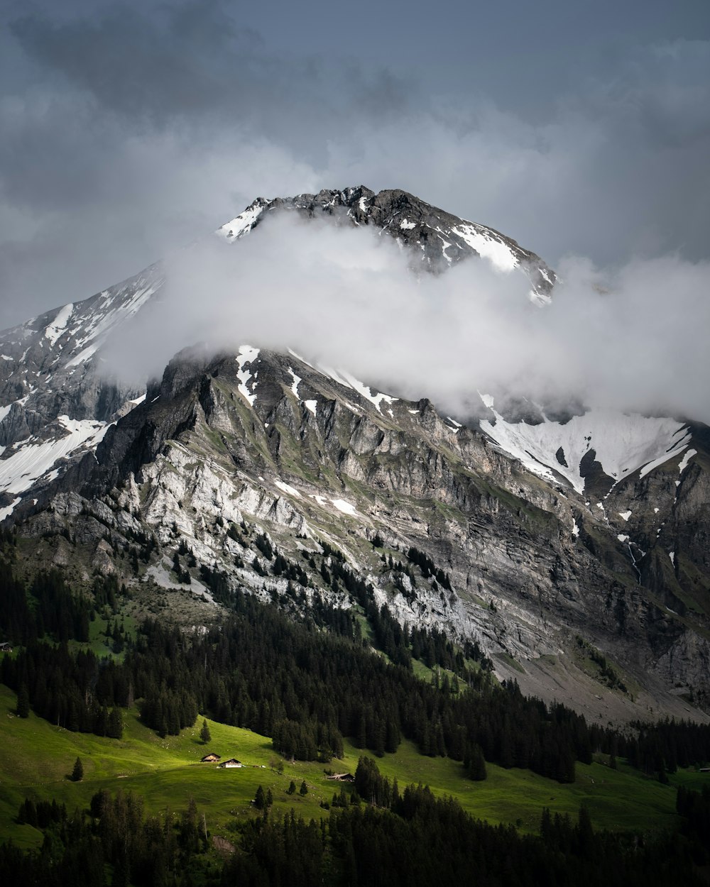 white clouds covering the snow-capped mountain