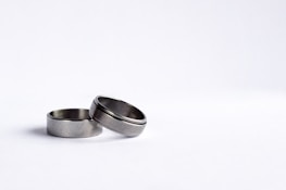 Modern rings arranged artfully on a sleek silver and white background.