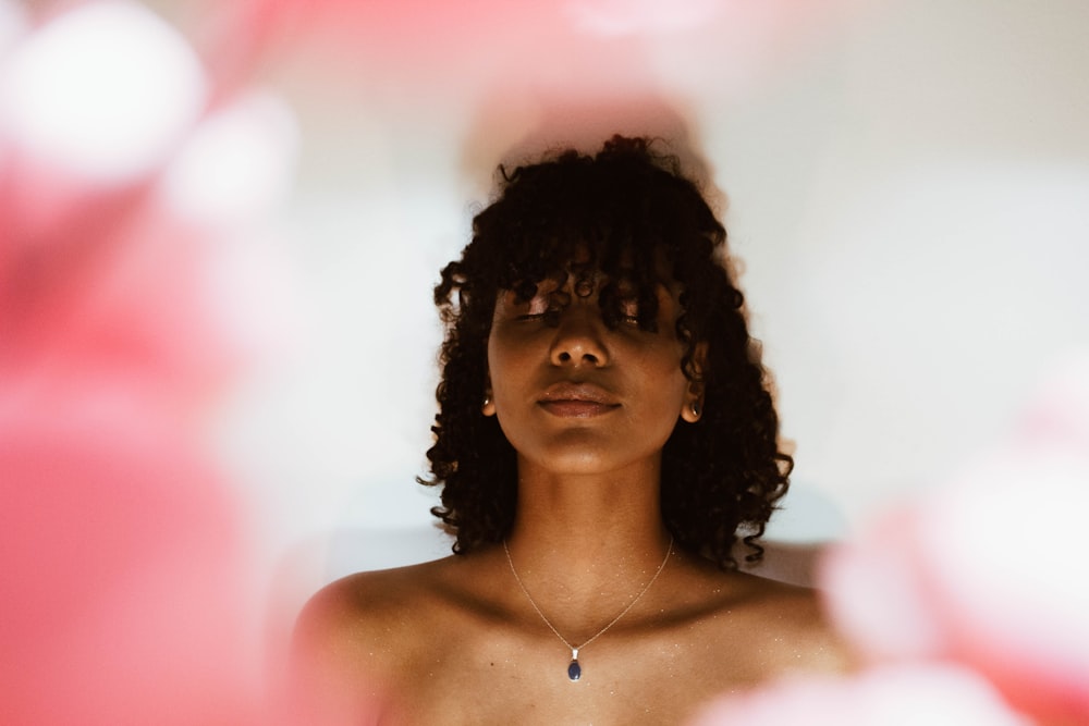 woman beside white surface