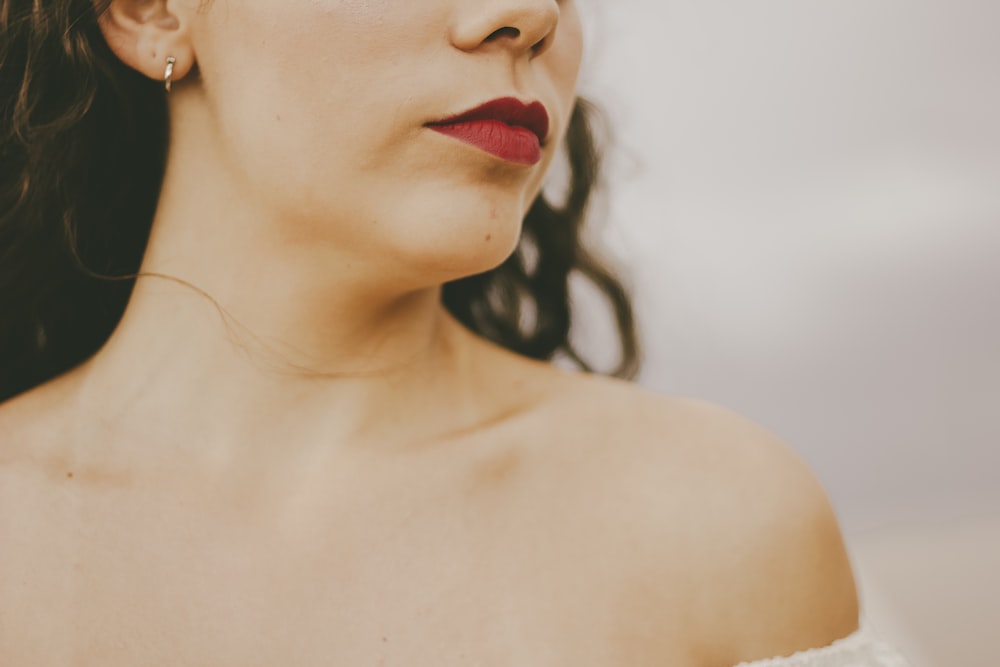 selective focus photography of woman wearing white off-shoulder top