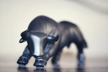 Graphic close-up of a print showing a stylized bull charging through a bearish market chart.