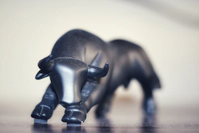 Graphic close-up of a print showing a stylized bull charging through a bearish market chart.