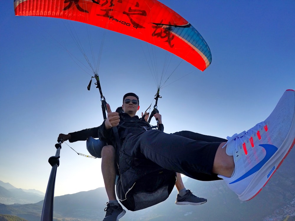 man taking selfie while paragliding
