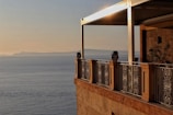 Romantic seaside resort balcony overlooking the calm ocean bathed in soft sunset light