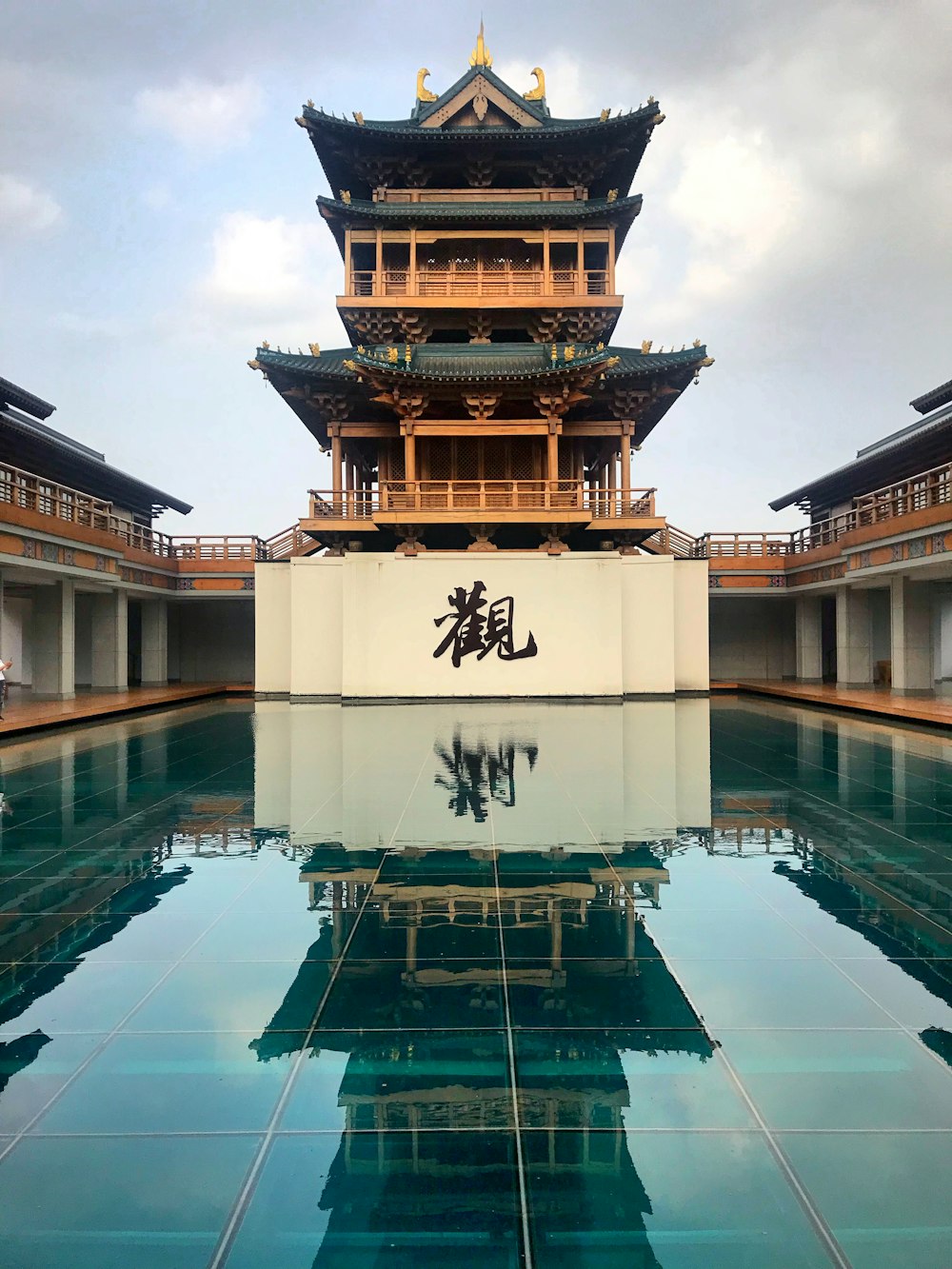 ancient brown and black building under cloudy sky