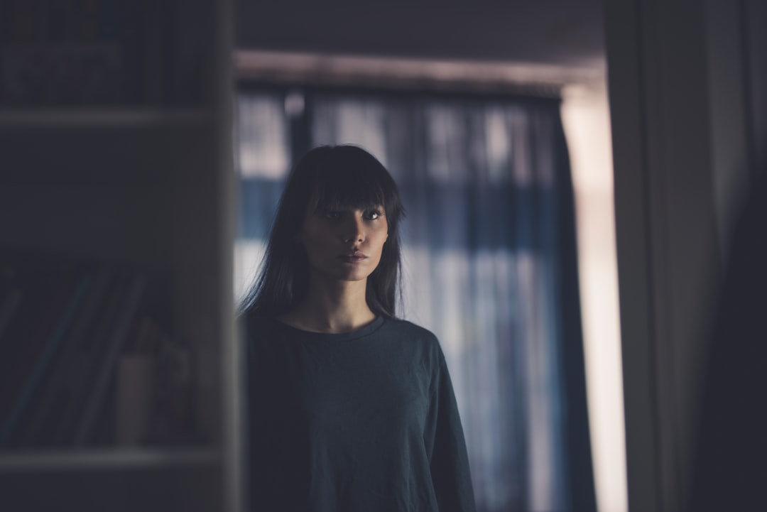 shallow focus photo of woman in black crew-neck long-sleeved shirt