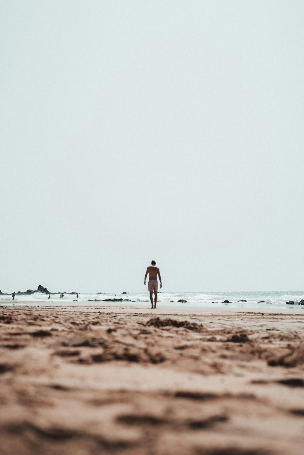 person walking on beach
