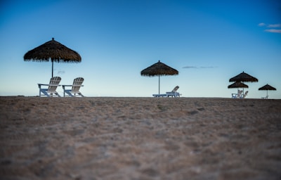 A serene beach destination with stylish lounge chairs.