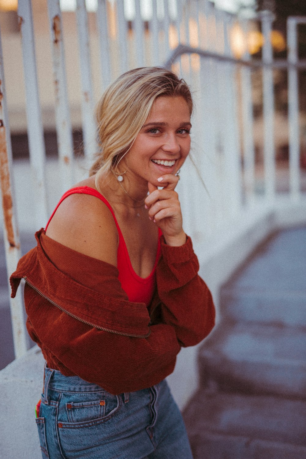 woman standing beside fence