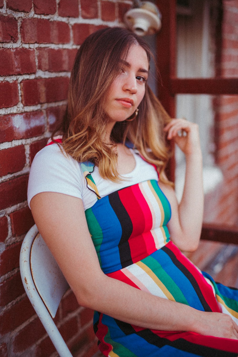 woman sitting on chair near wall