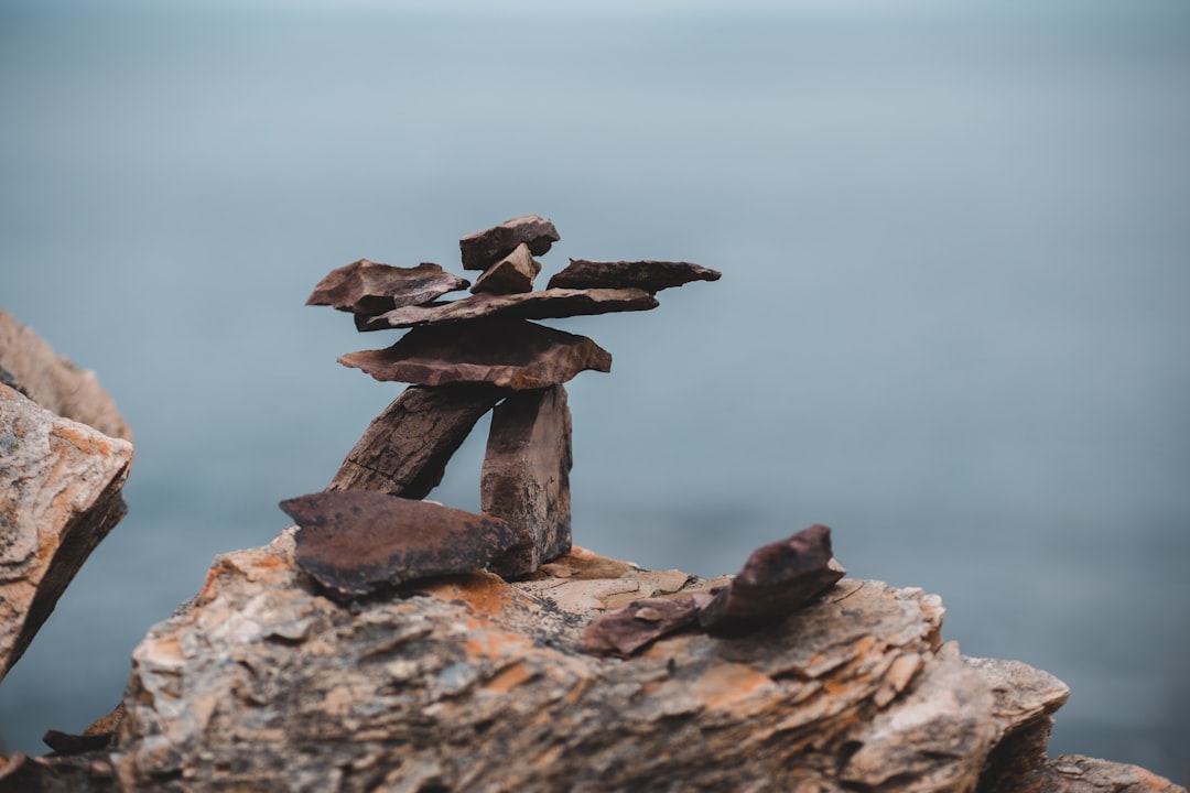 selective focus photography of stack of stones on rock