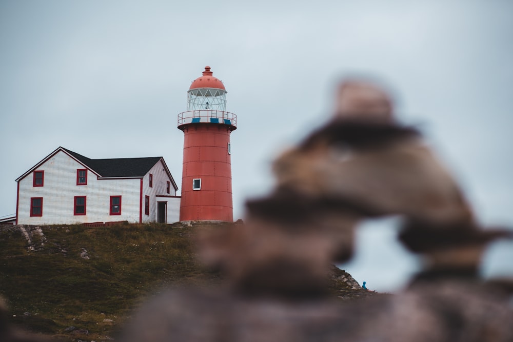 focus photography of red lighthouse