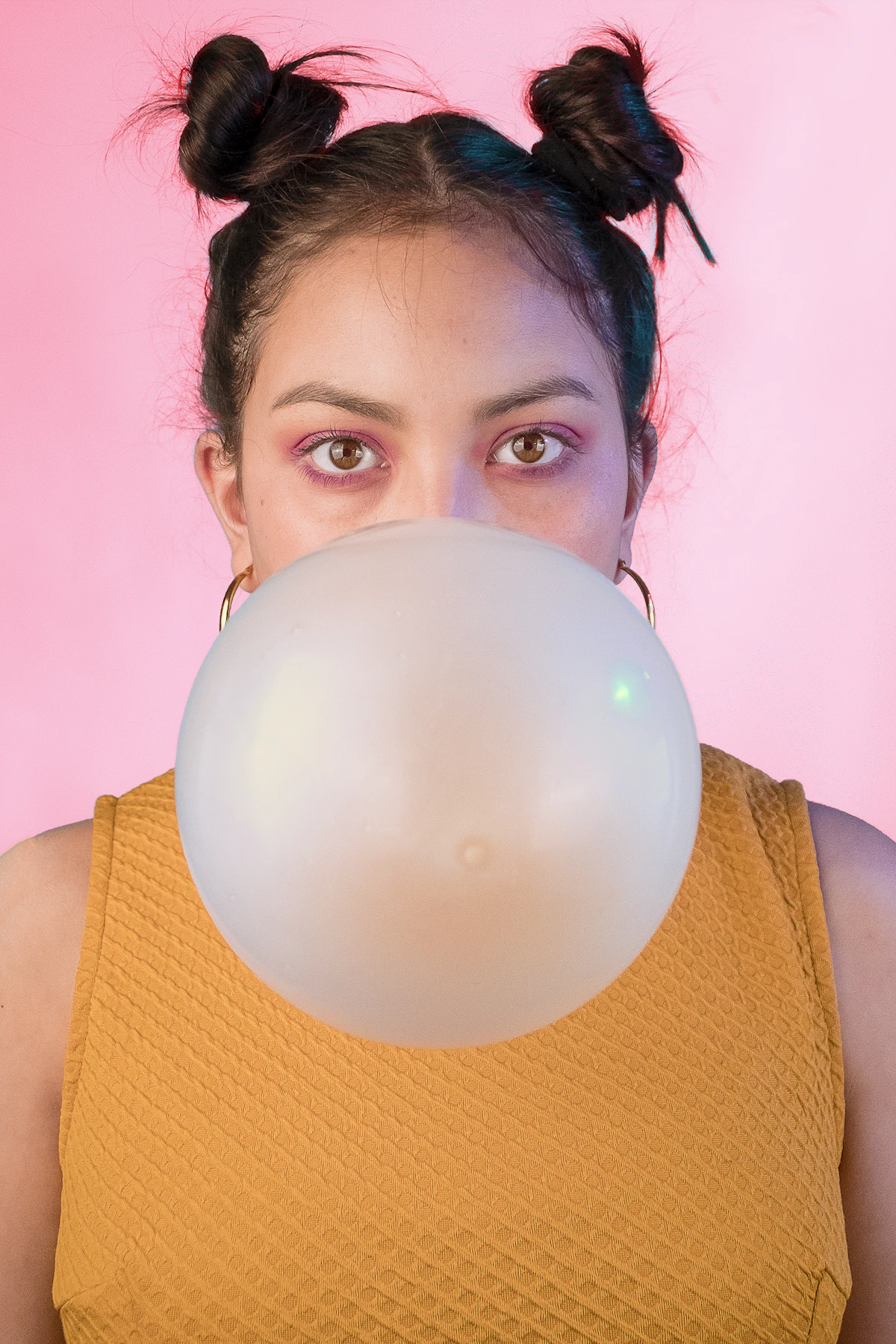 Pink bubble gum bubble on a pink background