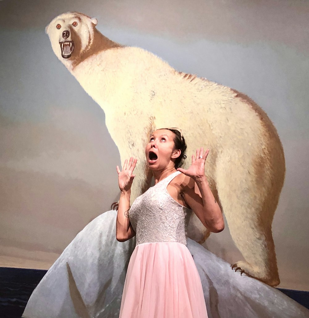 woman standing near polar bear painting