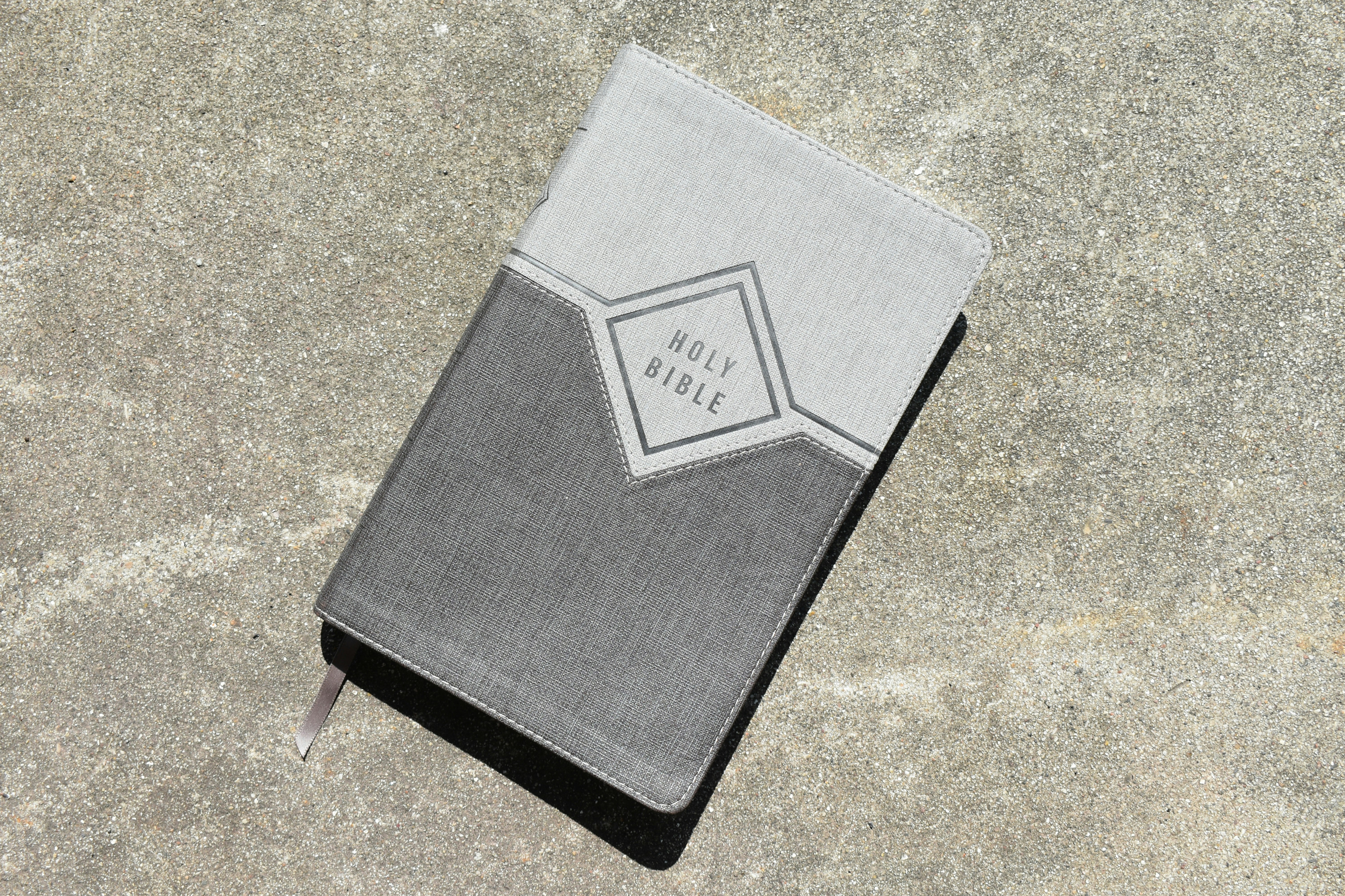 Holy Bible on pavement
