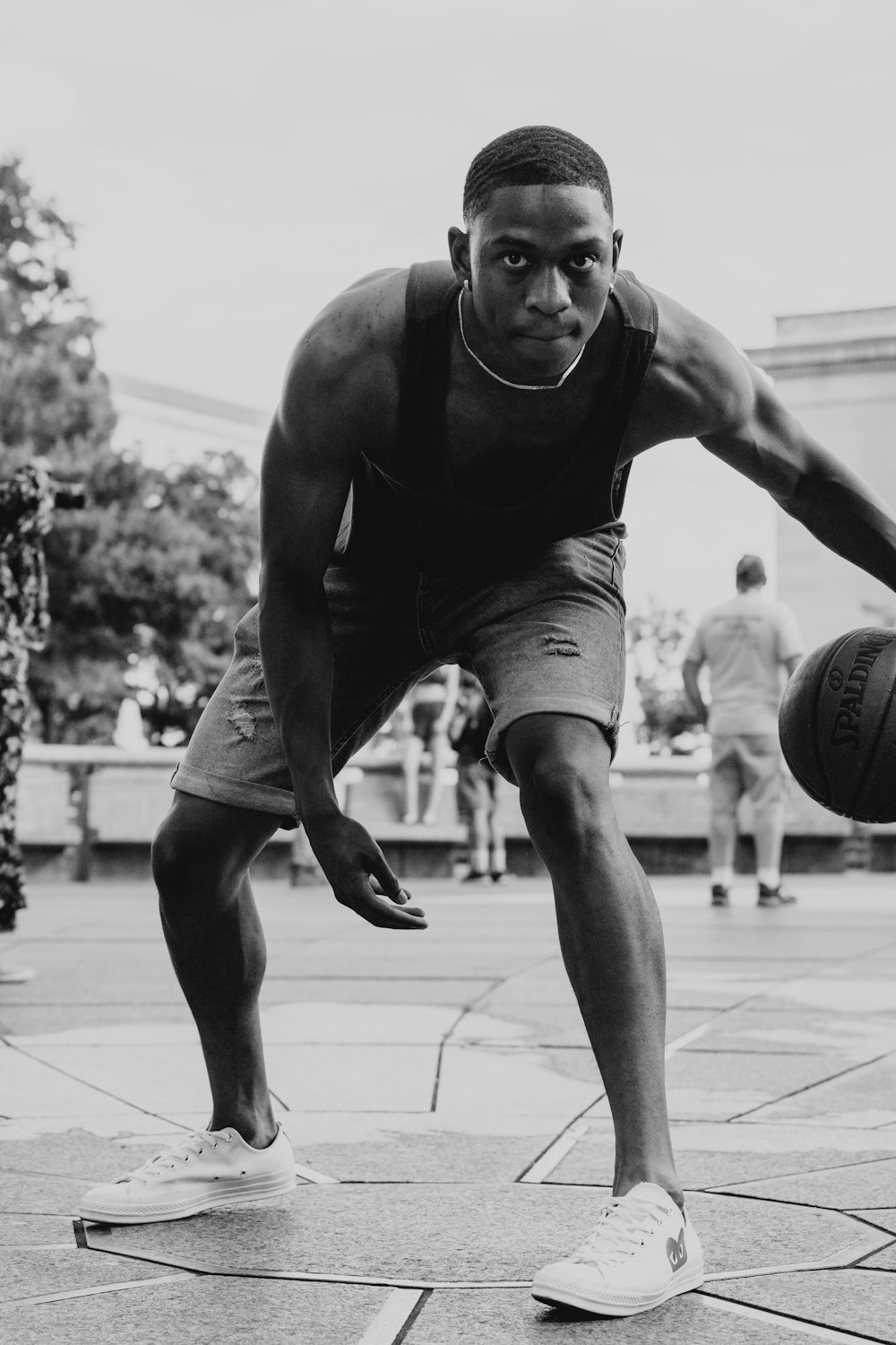 grayscale photo of man playing basketball