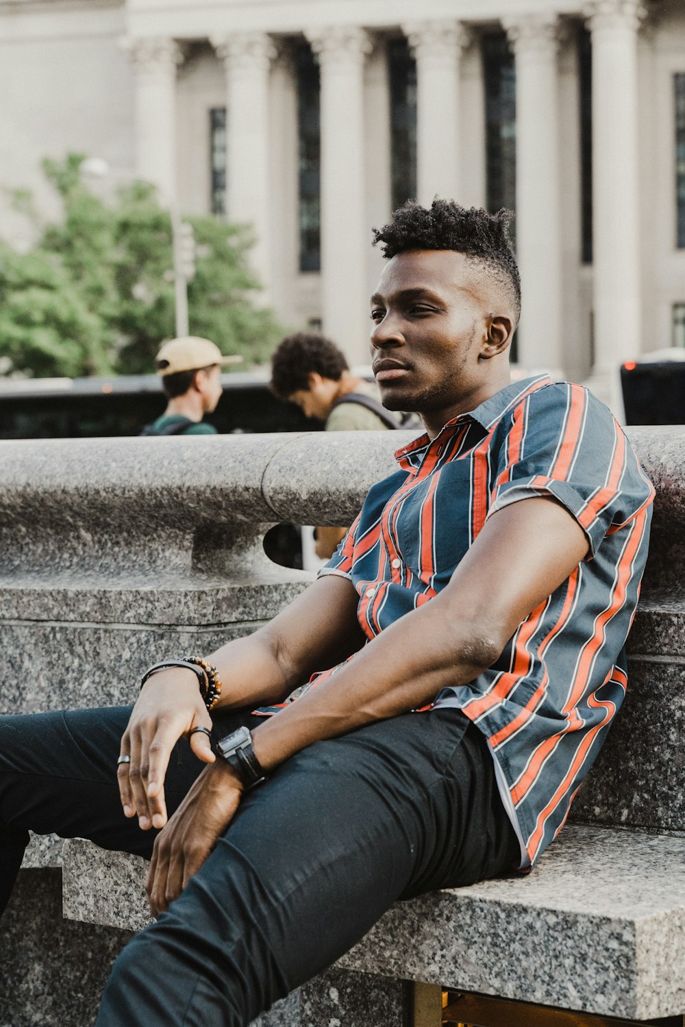 man sitting on concrete