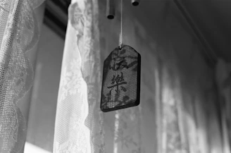 A close-up of a vibrant wooden plaque engraved with a floral pattern, glowing warmly under soft light.