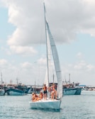 people on white sail boat