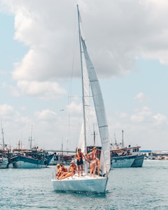 people on white sail boat