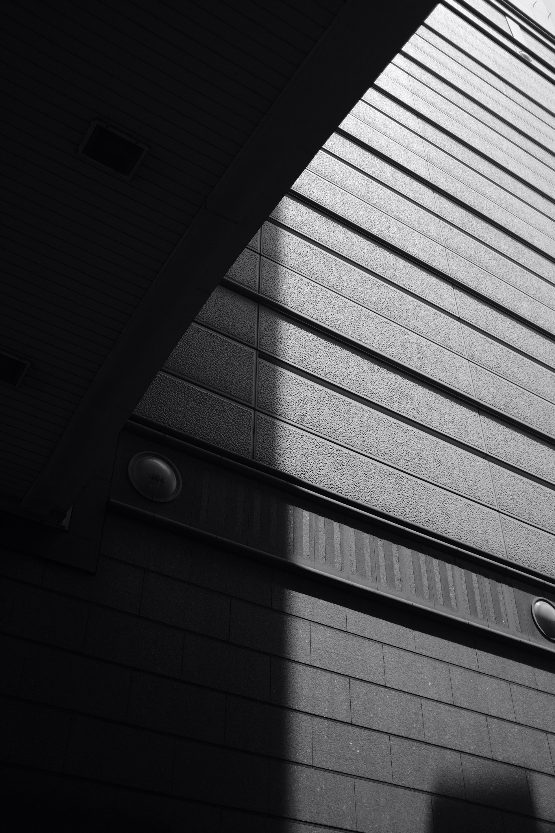 A striking black and white architectural shot capturing sharp angles and light contrasts of a modern building.