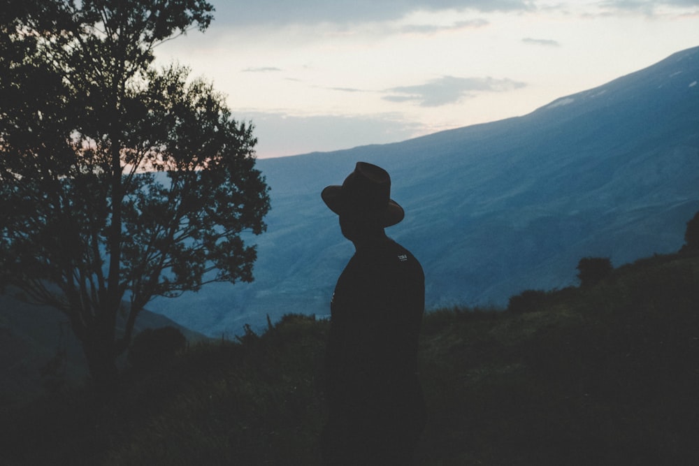 silhouette of man in round hat