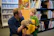 Warm teacher kneeling to talk with a happy child during storytime.