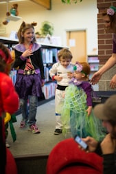 children in different costume standing inside room