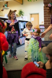 children in different costume standing inside room