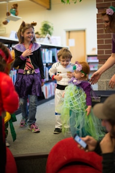 children in different costume standing inside room