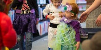 children in different costume standing inside room