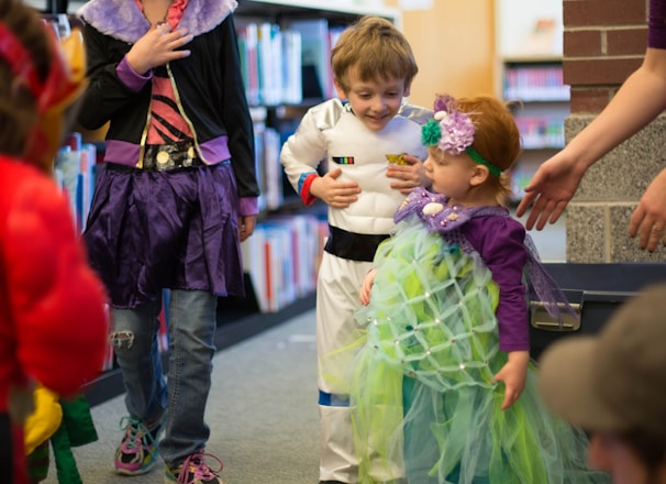 children in different costume standing inside room