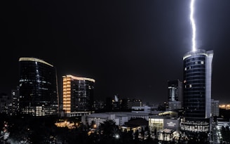 A cinematic still showing a dramatic urban nightscape with vivid lighting effects.